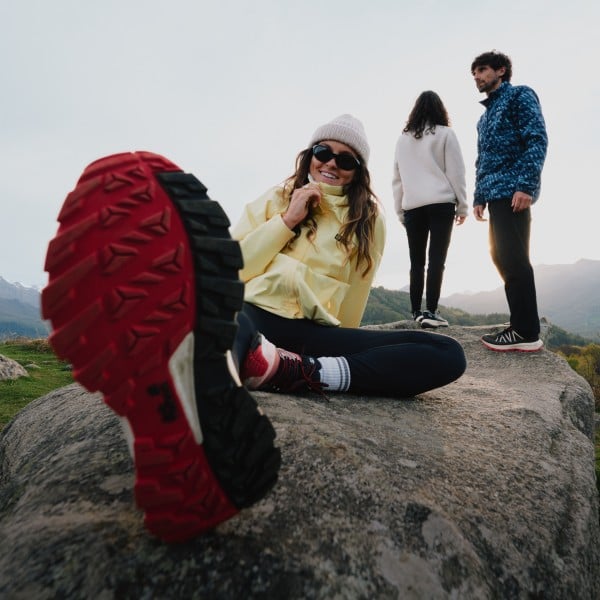 Photo taken by a drone of four hikers in summer clothing in a wooded mountainous area